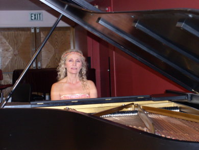 Mari framed by open piano